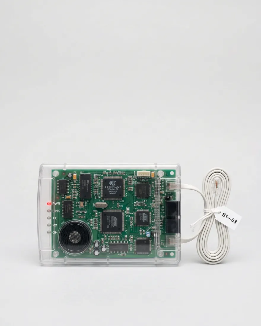 A transparent dial-up modem with a green circuit board. Its red light blinks.